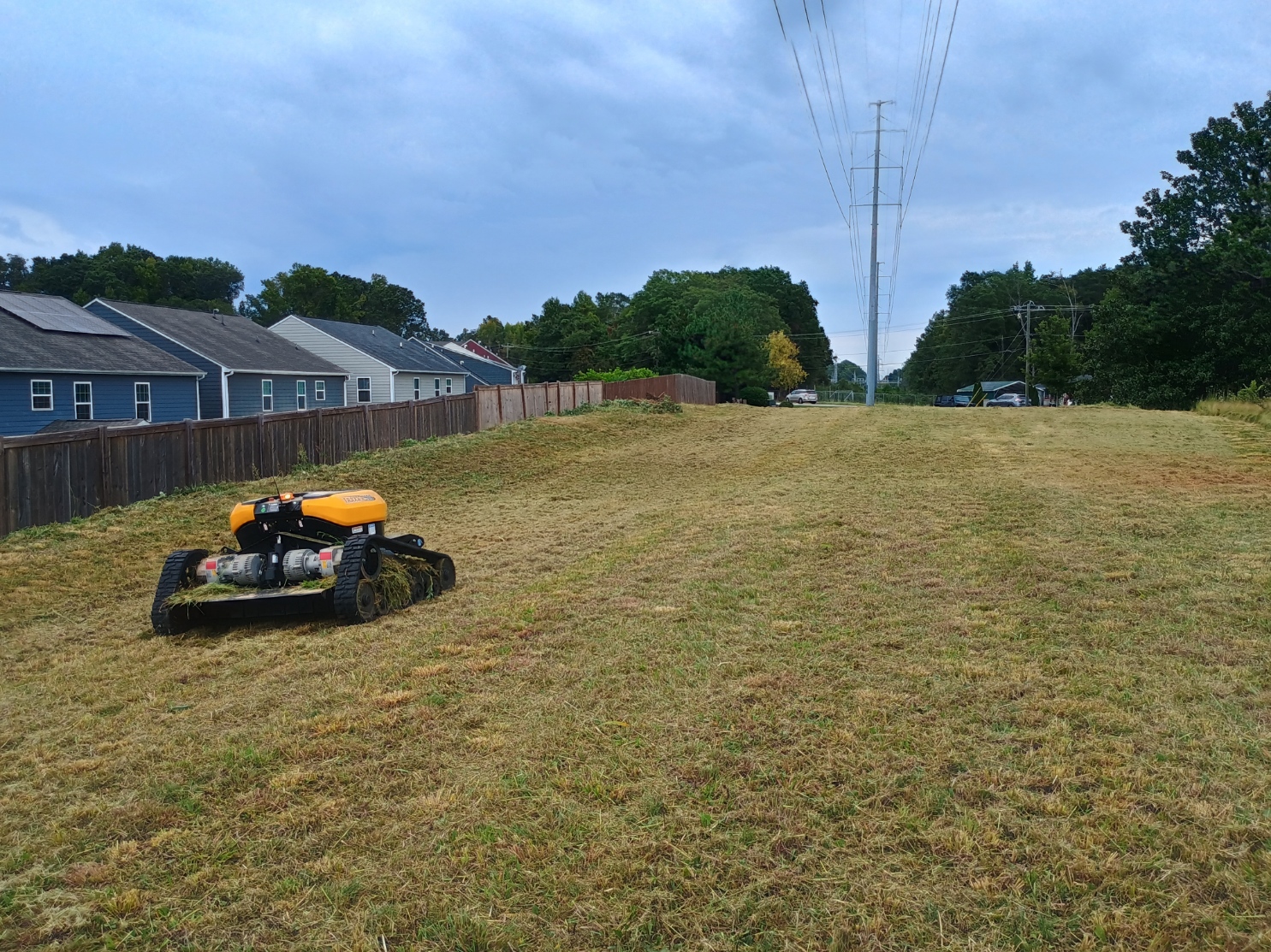 Remote controlled forestry mulcher performing right of way mowing under power lines in Greer SC