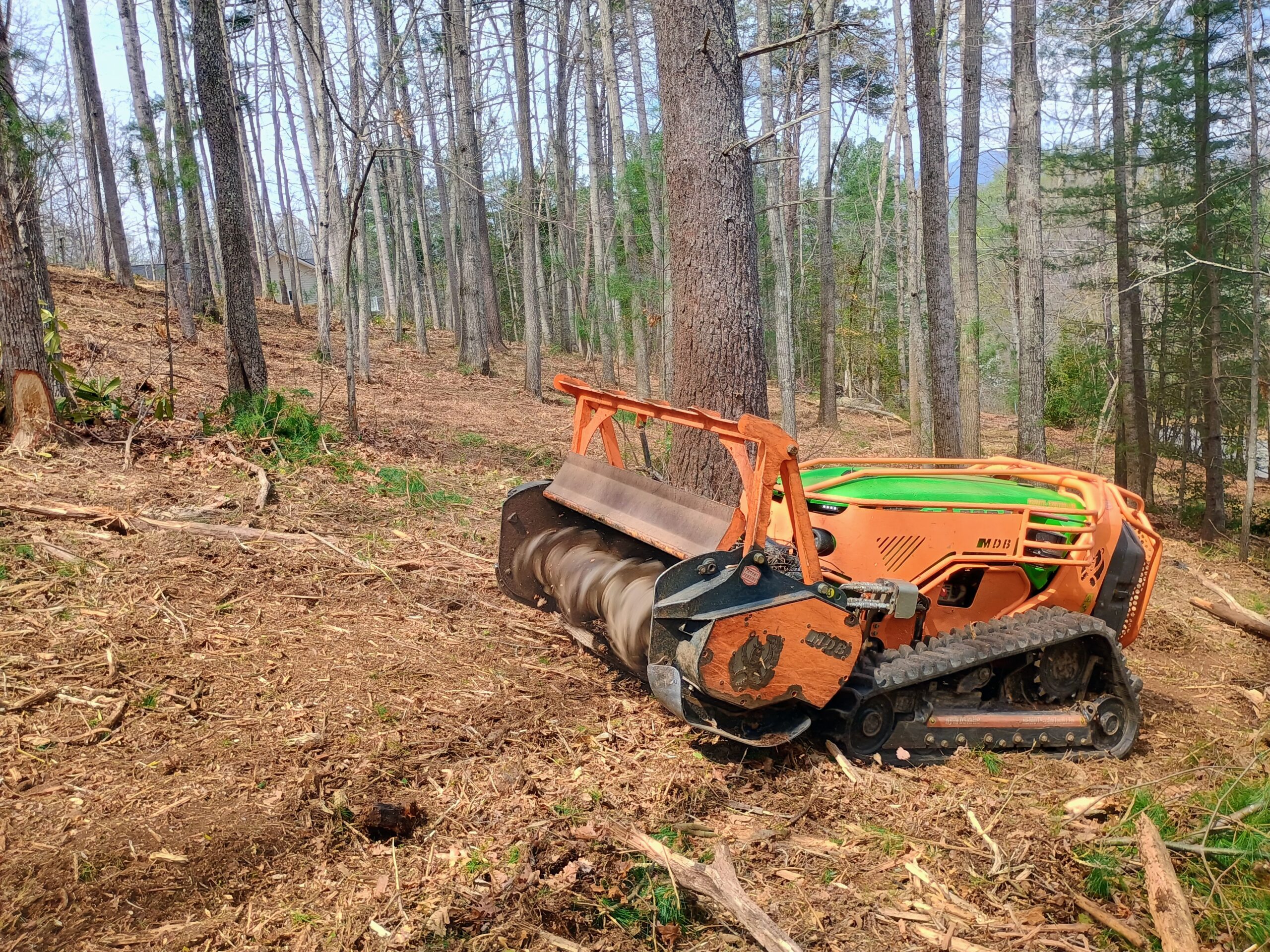 Green Climber LV600 forestry mulcher clearing wooded slope in Black Mountain NC using remote controlled equipment